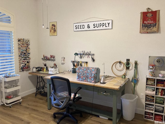 office space featuring hardwood / wood-style floors and built in desk