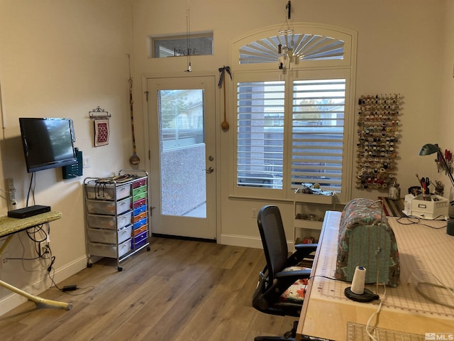 office space with a chandelier and wood-type flooring