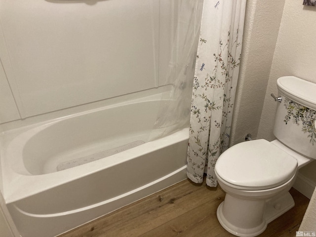 bathroom with toilet, shower / bath combo with shower curtain, and wood-type flooring