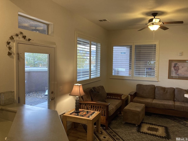 living room featuring plenty of natural light and ceiling fan