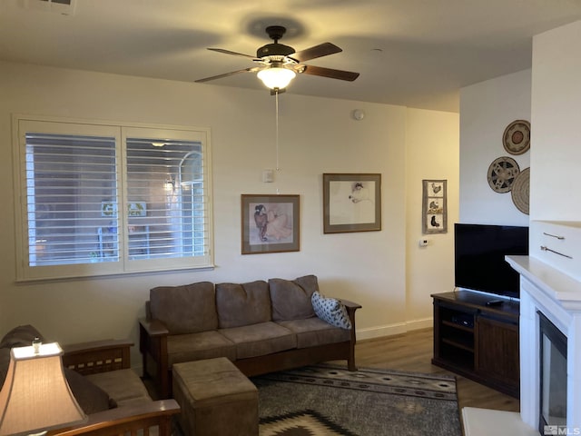 living room with ceiling fan and dark hardwood / wood-style floors