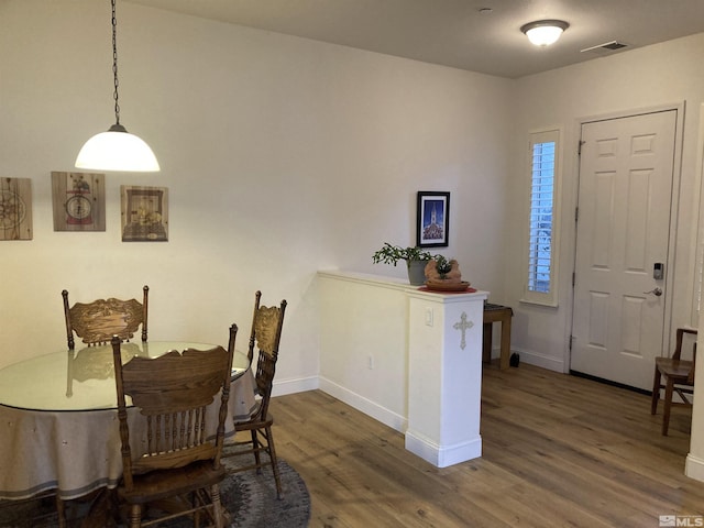 dining space featuring dark wood-type flooring