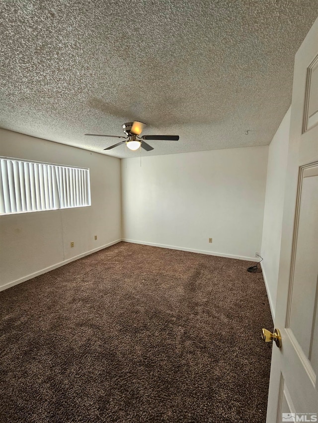 carpeted spare room featuring a textured ceiling and ceiling fan