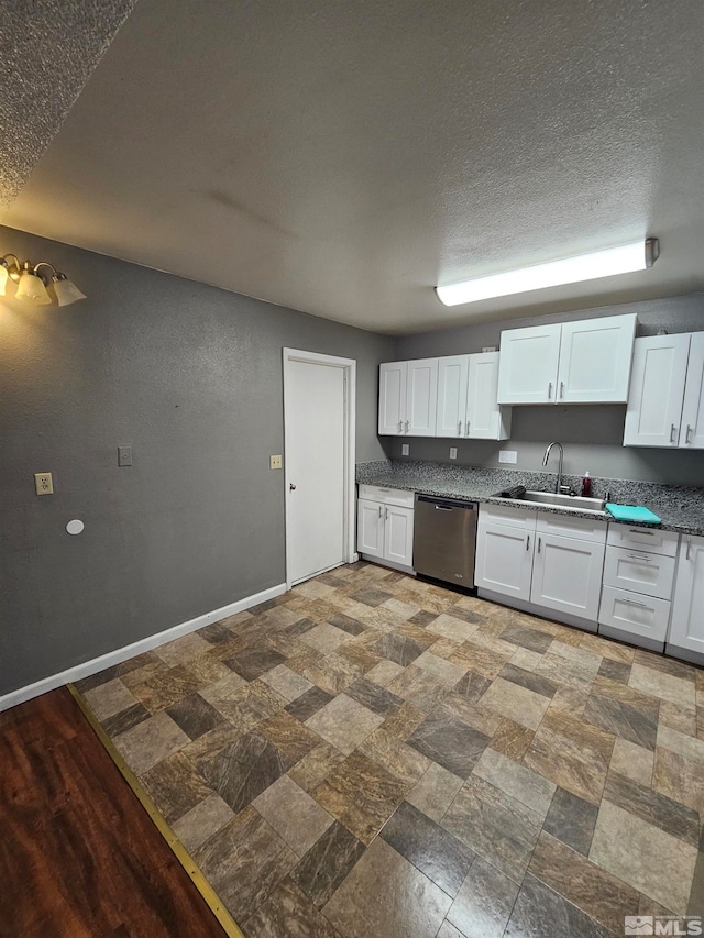 kitchen featuring white cabinetry, sink, a textured ceiling, and dishwasher