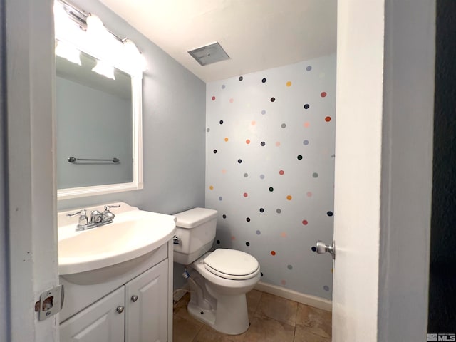 bathroom with vanity, tile patterned flooring, and toilet