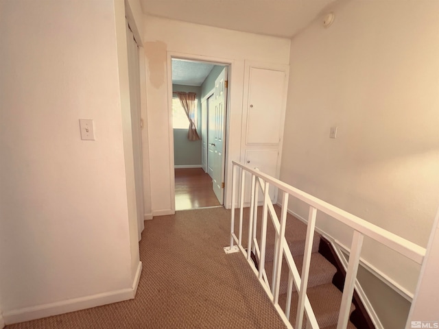 corridor featuring dark colored carpet