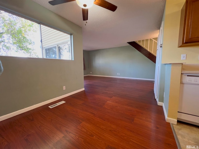 interior space featuring hardwood / wood-style floors, ceiling fan, and a textured ceiling