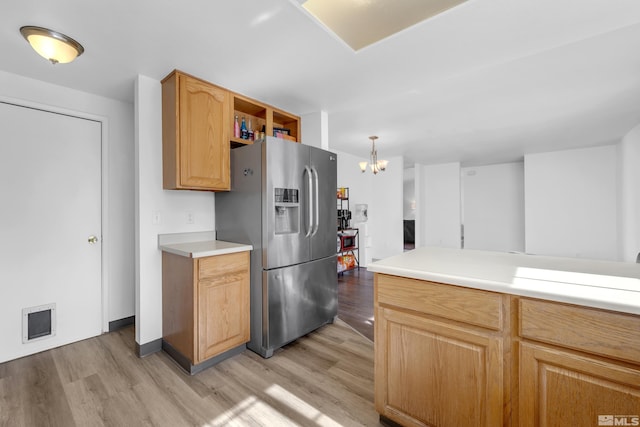 kitchen with light hardwood / wood-style flooring, decorative light fixtures, stainless steel fridge with ice dispenser, and an inviting chandelier