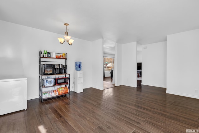 interior space with dark hardwood / wood-style floors and an inviting chandelier