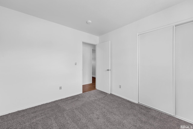 unfurnished bedroom with carpet floors and a closet