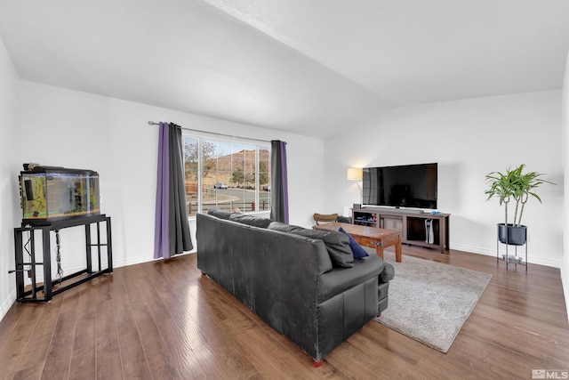 living room with hardwood / wood-style floors and vaulted ceiling