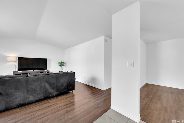 living room with hardwood / wood-style floors and vaulted ceiling