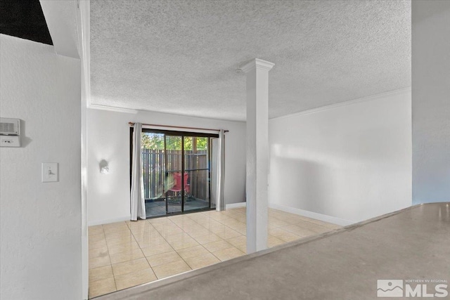 tiled empty room with ornate columns and a textured ceiling