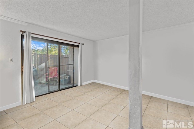 tiled empty room with a textured ceiling and crown molding