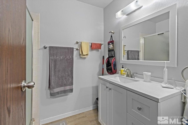 bathroom featuring vanity, hardwood / wood-style flooring, and an enclosed shower