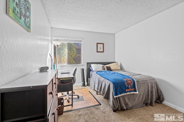 bedroom with carpet flooring and a textured ceiling