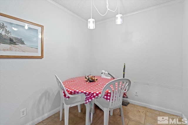 tiled dining area with a textured ceiling and crown molding