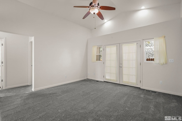 unfurnished room featuring french doors, dark colored carpet, ceiling fan, and vaulted ceiling