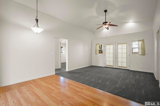 unfurnished room featuring hardwood / wood-style floors, french doors, lofted ceiling, and ceiling fan