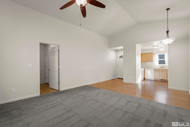 unfurnished living room with light wood-type flooring, lofted ceiling, and ceiling fan