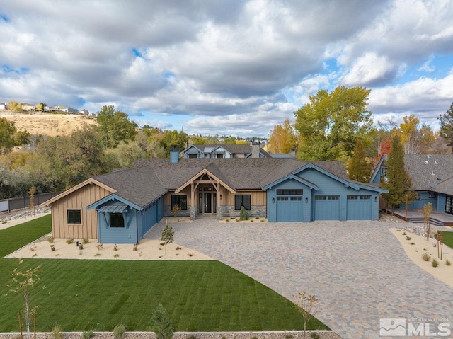 single story home featuring a front lawn and a garage