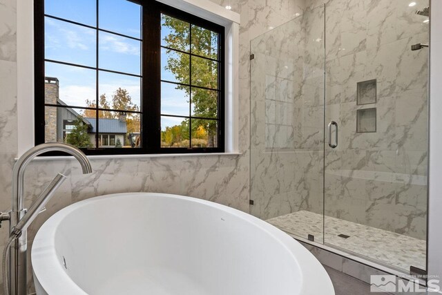 bathroom with shower with separate bathtub