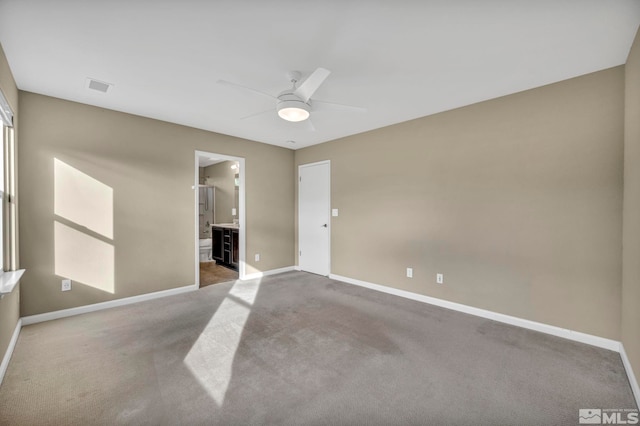 unfurnished room with ceiling fan and carpet