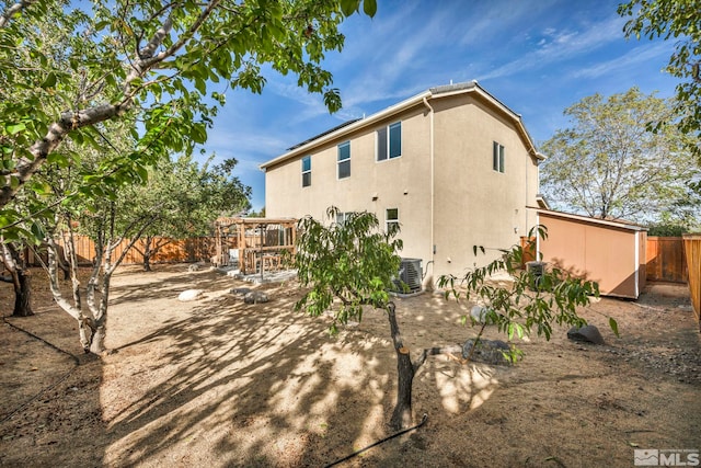 rear view of property with central AC unit