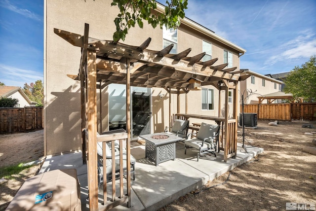 view of patio / terrace with a fire pit and a pergola