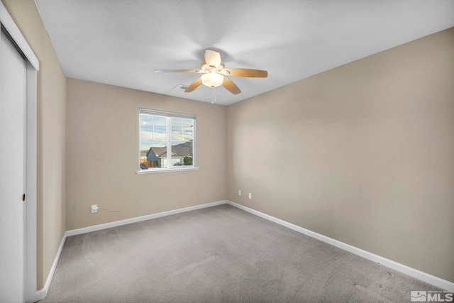 empty room with ceiling fan and carpet