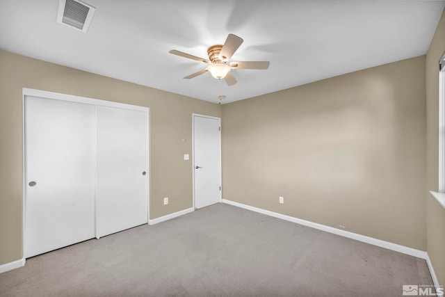 unfurnished bedroom with ceiling fan, a closet, and light colored carpet