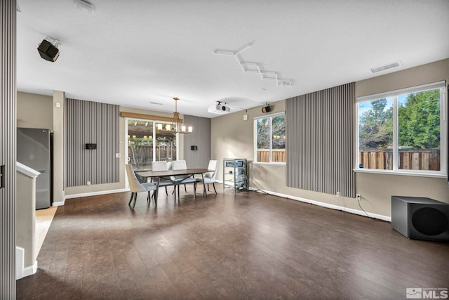 dining space featuring dark hardwood / wood-style floors and a healthy amount of sunlight