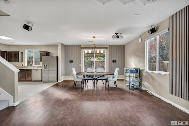 dining space with a wealth of natural light and light hardwood / wood-style floors