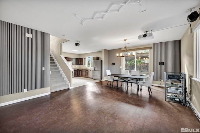 dining room featuring wood-type flooring and an inviting chandelier