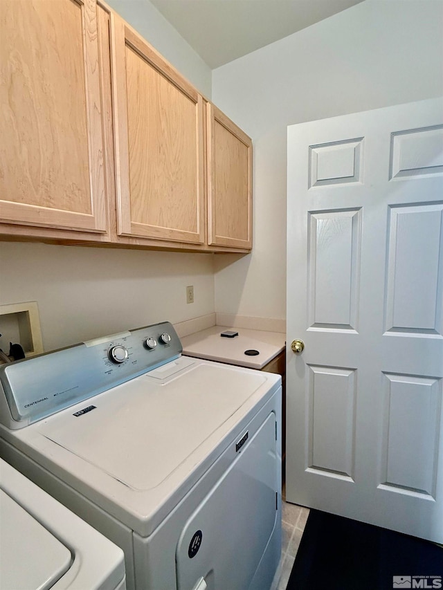 laundry room with cabinets and washer and clothes dryer