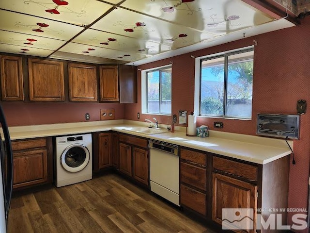 kitchen featuring dishwasher, dark hardwood / wood-style floors, sink, and washer / clothes dryer