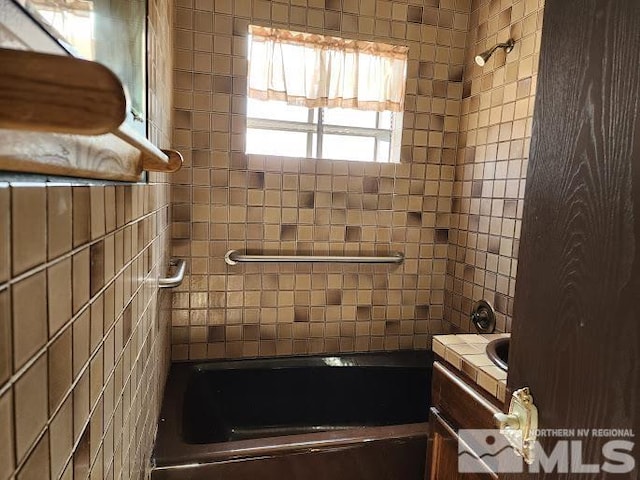 bathroom featuring vanity and tiled shower / bath combo