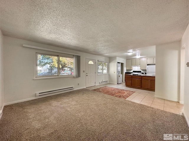 unfurnished living room featuring baseboard heating, light carpet, and a textured ceiling