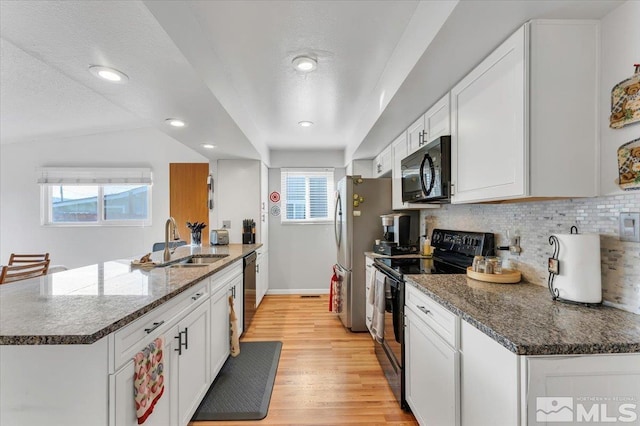 kitchen featuring white cabinets, plenty of natural light, black appliances, and sink