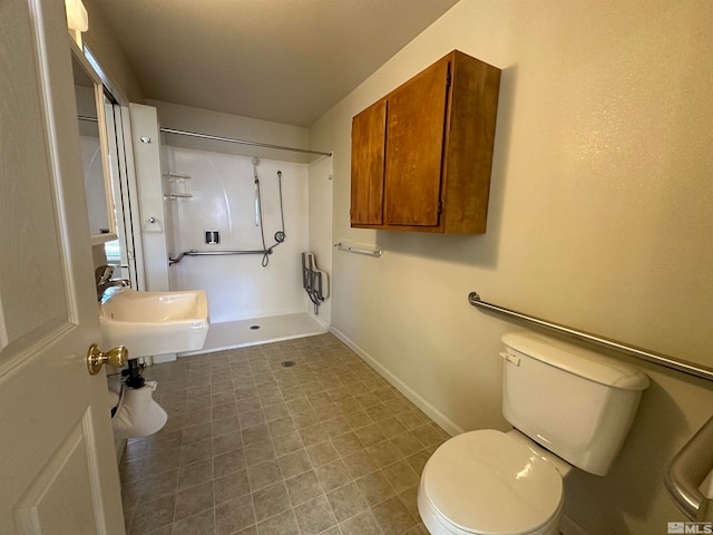 bathroom with a shower, toilet, and sink