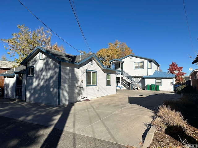 rear view of property featuring a garage