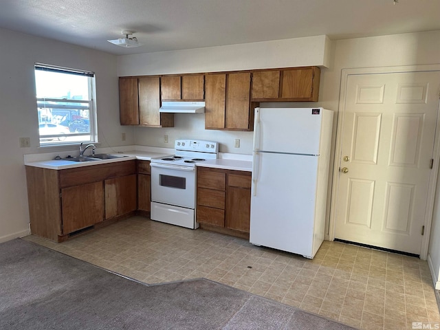 kitchen featuring white appliances and sink