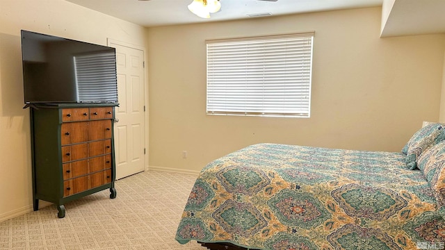 bedroom featuring ceiling fan and light carpet