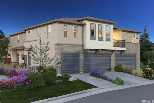 view of front facade featuring a balcony and a garage