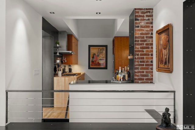 bar featuring wall chimney range hood