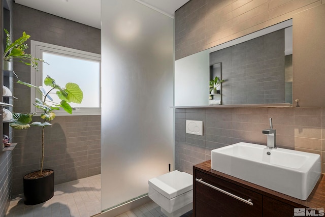 bathroom featuring vanity and tile walls