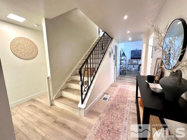 stairs featuring hardwood / wood-style flooring