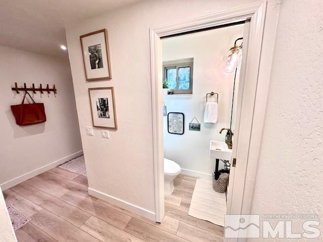 bathroom featuring hardwood / wood-style flooring and toilet