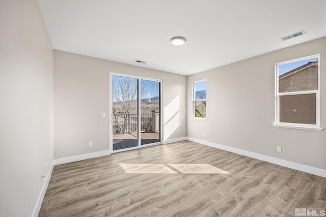 empty room with light hardwood / wood-style floors