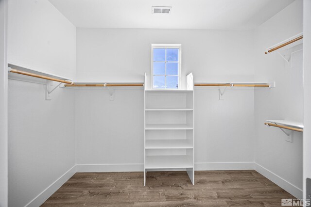 spacious closet with hardwood / wood-style floors